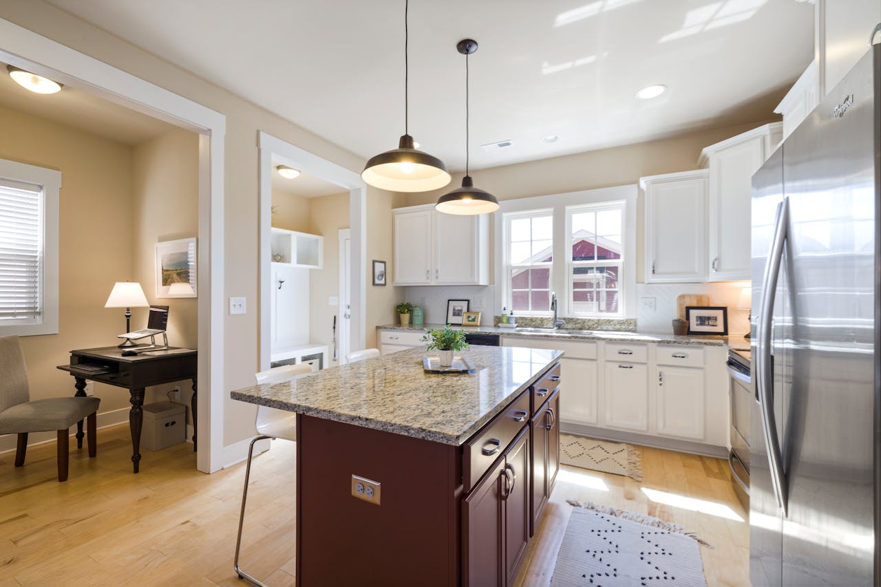 digital-01 Bright and spacious kitchen interior with island and stainless steel appliances.