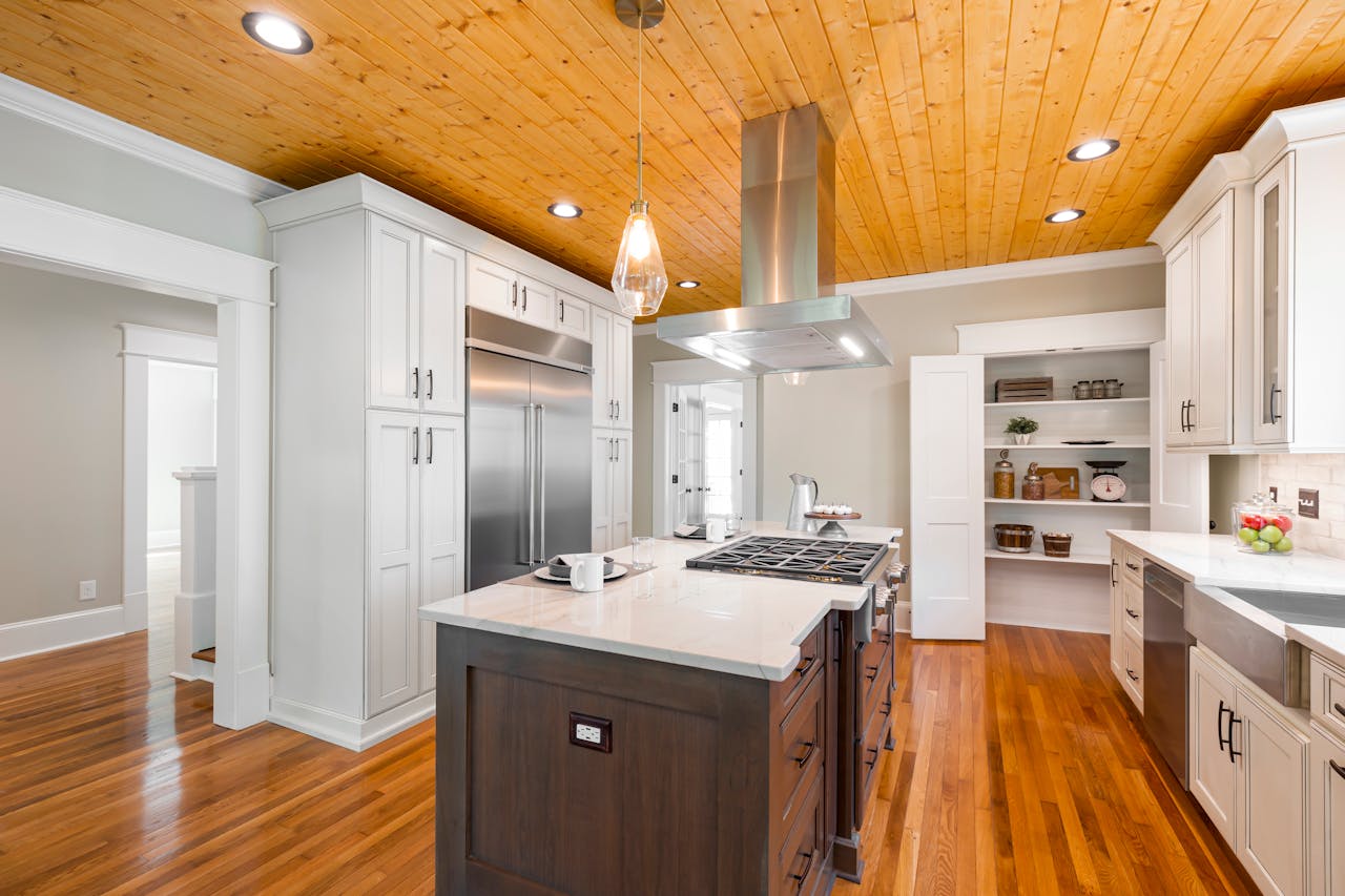 brand-01 Spacious kitchen with wood accents, stainless appliances, and central island.