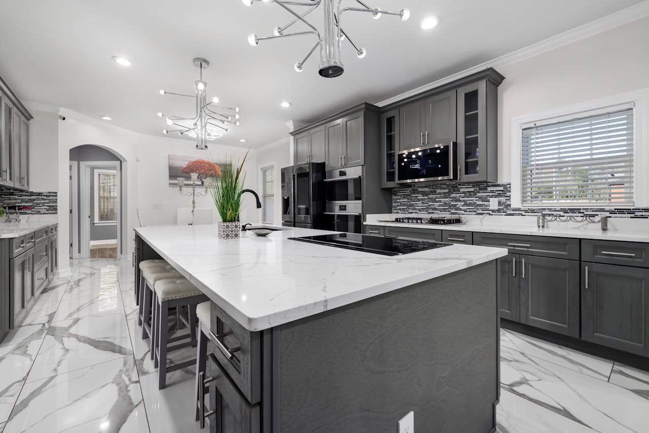 mobile-01 Experience elegance in this luxury modern kitchen featuring marble countertops, sleek cabinetry, and stylish lighting.
